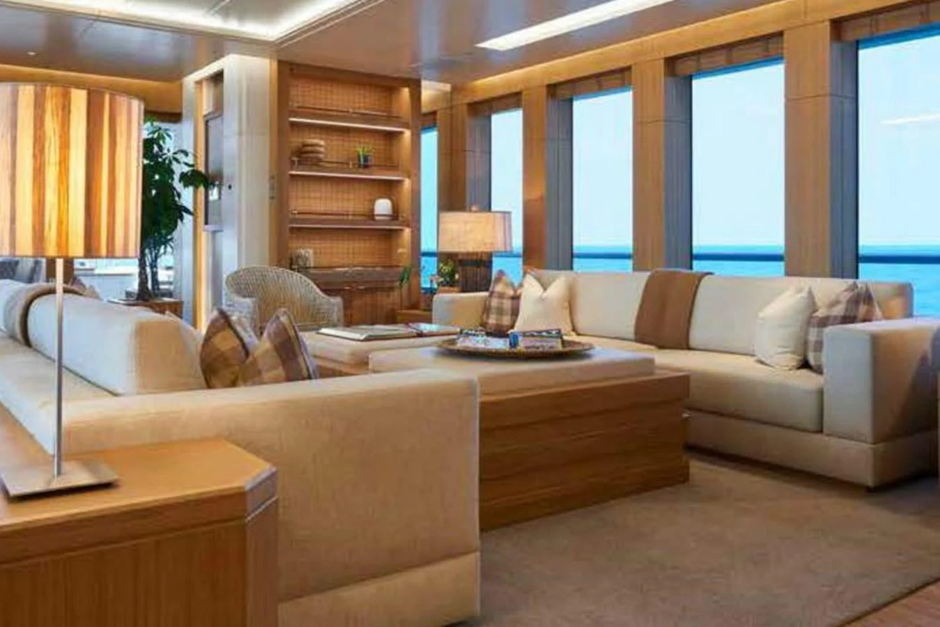The salon features plush seating and elegant decor with large windows offering stunning ocean views. aboard DYTAN Yacht for Sale