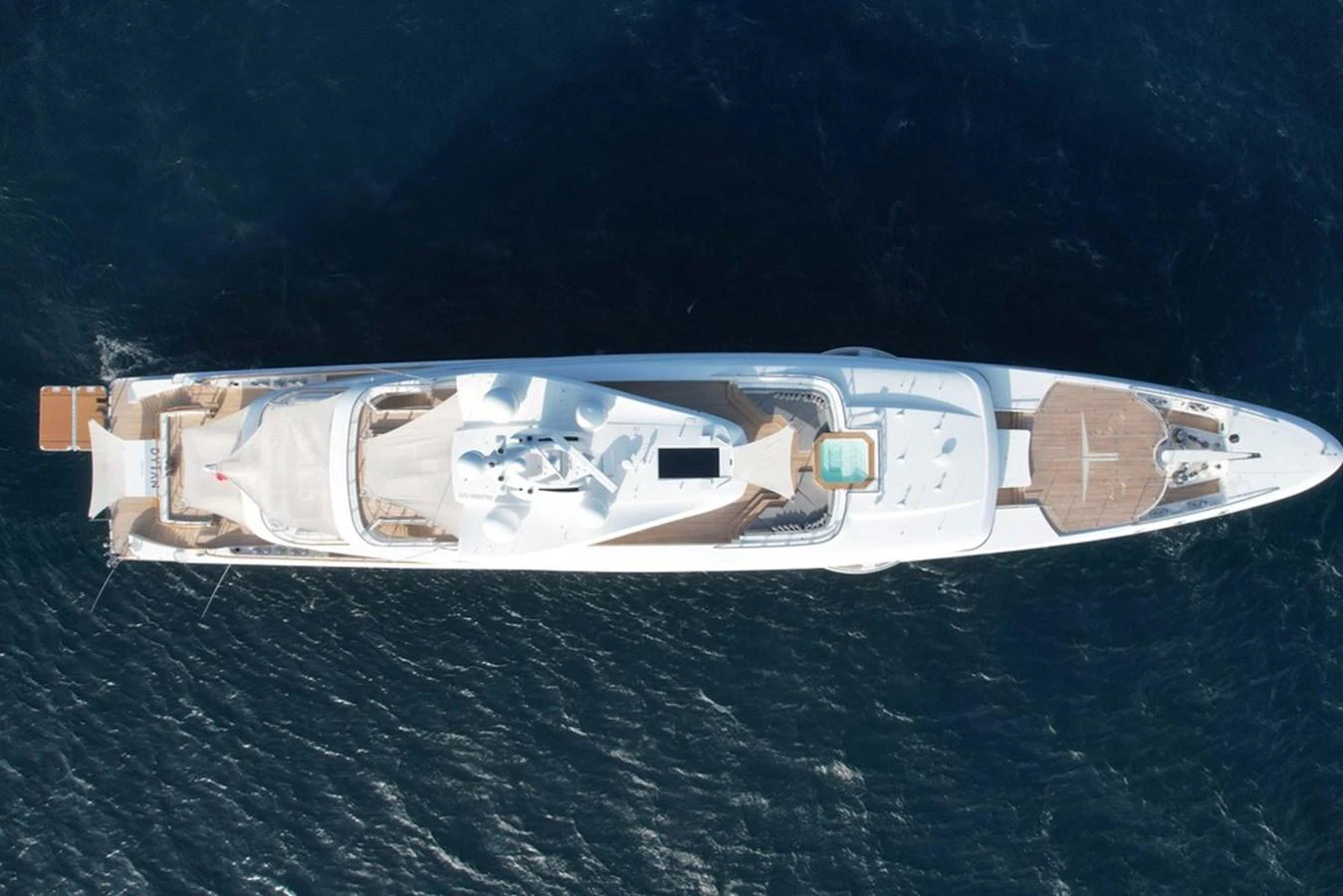 An aerial view of a luxurious yacht showcasing its expansive deck and sleek design. aboard DYTAN Yacht for Sale