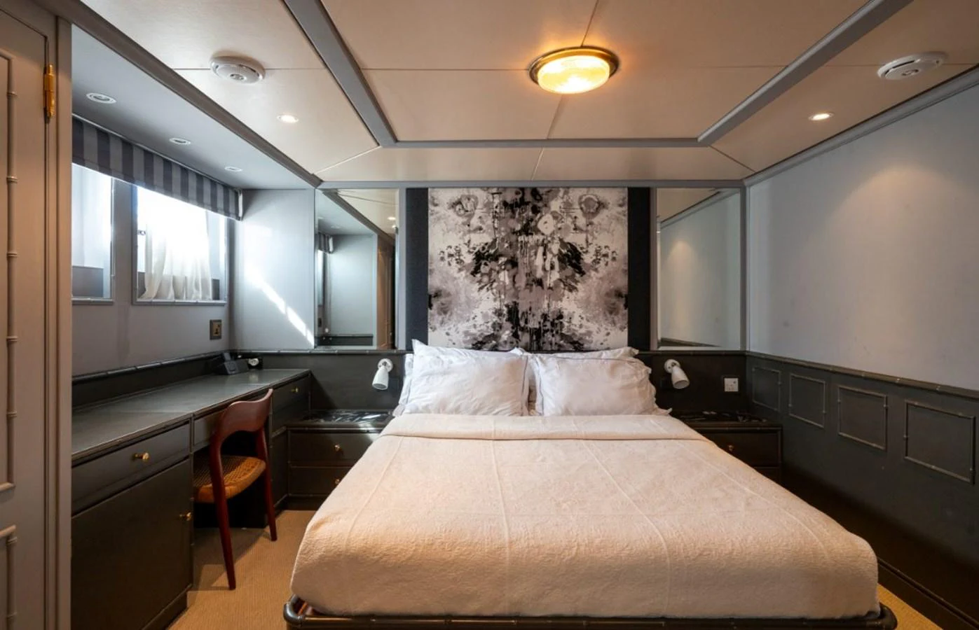 A luxurious stateroom featuring a large bed, elegant decor, and ample natural light. aboard STELLA FIERA II Yacht for Sale