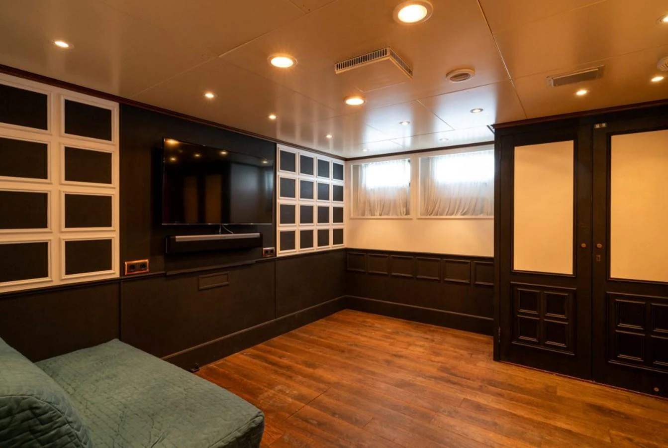 This cozy interior space features a large TV and comfortable seating, perfect for relaxation. aboard STELLA FIERA II Yacht for Sale