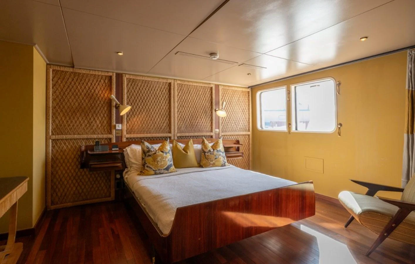 A cozy stateroom with a large bed and natural light streaming through the windows. aboard STELLA FIERA II Yacht for Sale