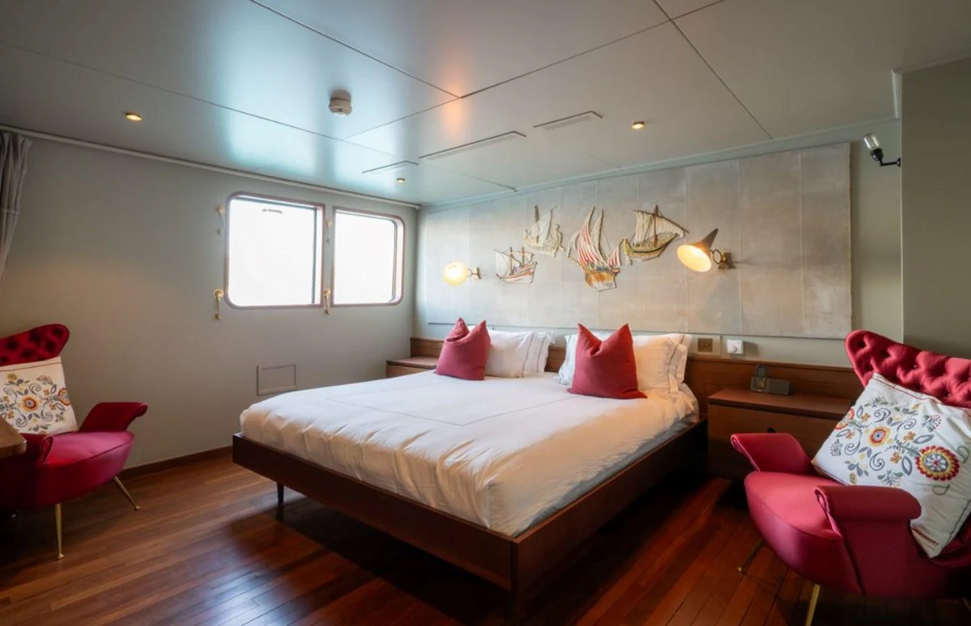 A luxurious stateroom featuring a large bed, elegant decor, and ample natural light. aboard STELLA FIERA II Yacht for Sale