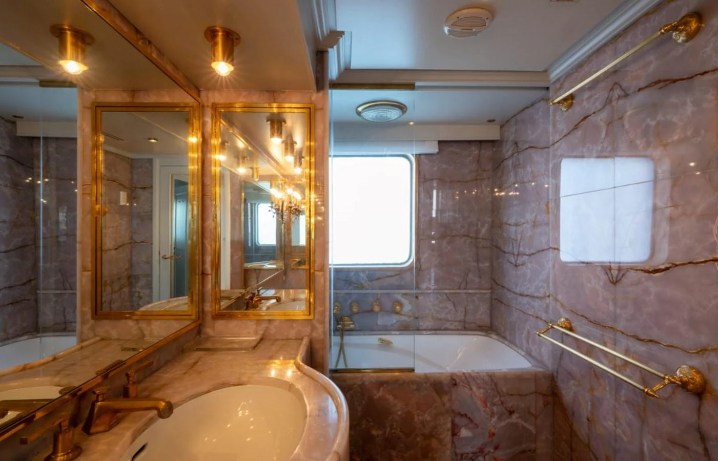 The yacht's bathroom features luxurious marble surfaces and elegant gold fixtures. aboard STELLA FIERA II Yacht for Sale