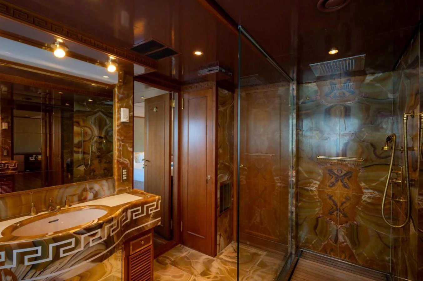 The luxurious bathroom features elegant marble finishes and a spacious glass-enclosed shower. aboard STELLA FIERA II Yacht for Sale