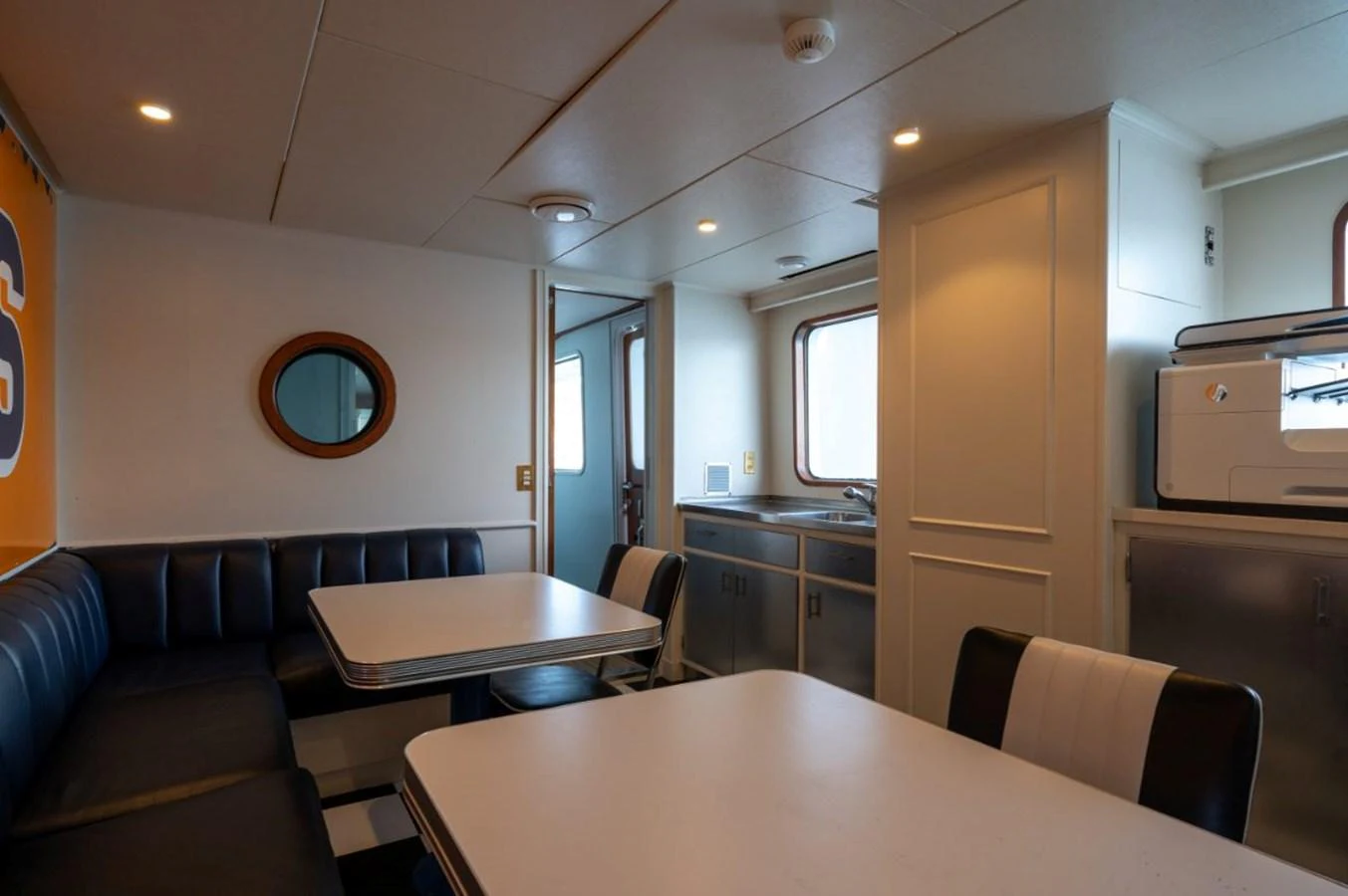 The yacht's galley features a cozy dining area with comfortable seating and ample natural light. aboard STELLA FIERA II Yacht for Sale