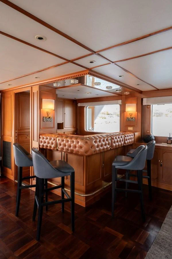 The yacht's interior features a luxurious bar area with plush seating and elegant wood finishes. aboard STELLA FIERA II Yacht for Sale