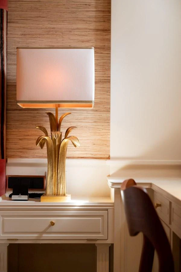 A stylish interior space featuring a desk with a decorative lamp and a chair. aboard STELLA FIERA II Yacht for Sale