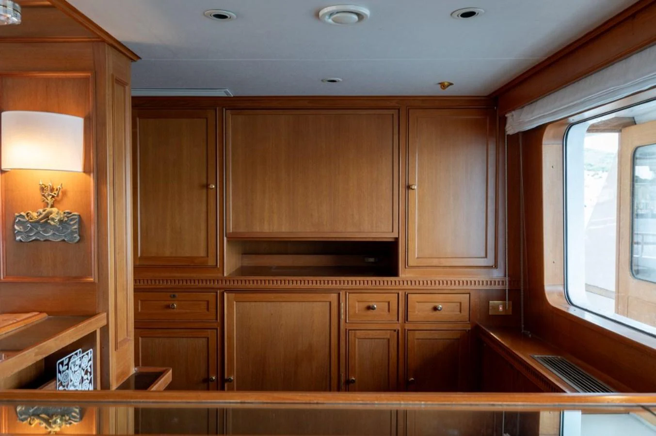 The yacht's interior features elegant wooden cabinetry and large windows for natural light. aboard STELLA FIERA II Yacht for Sale