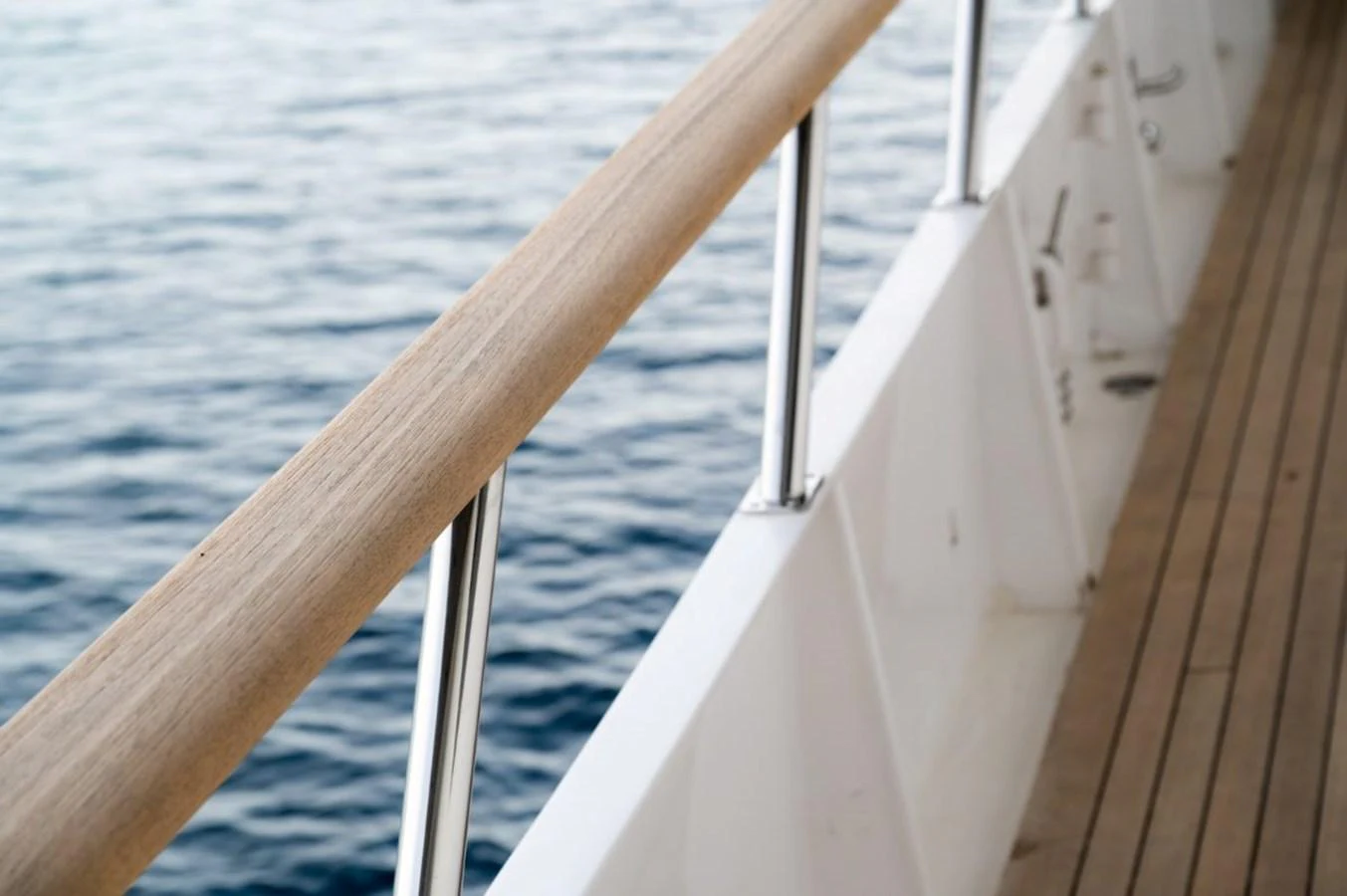 A close-up view of the yacht's railing and deck, showcasing the quality craftsmanship and serene ocean backdrop. aboard STELLA FIERA II Yacht for Sale