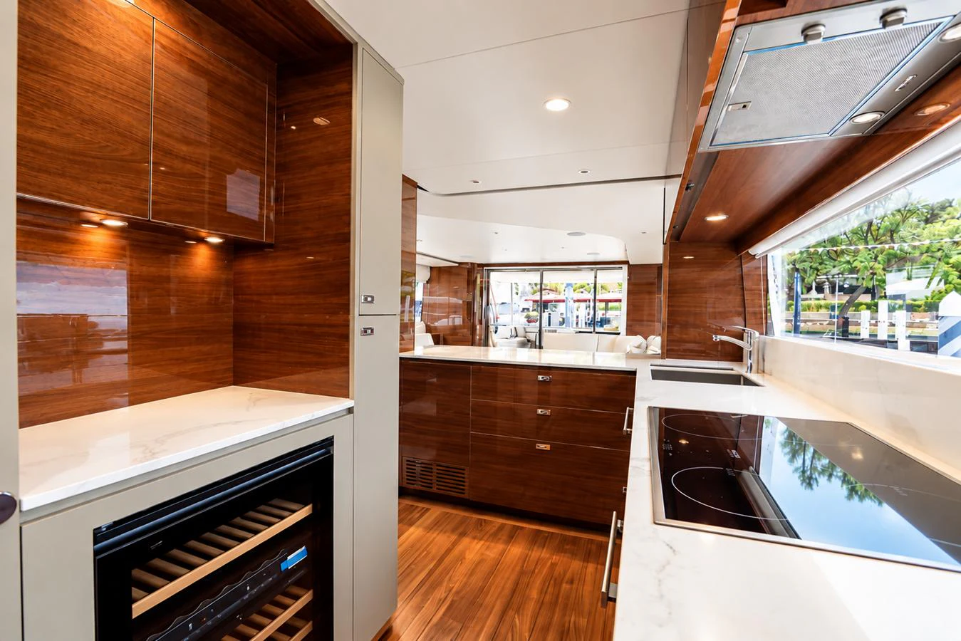 The yacht's galley features modern appliances and sleek wooden cabinetry, creating a stylish and functional space. aboard MOONFLOWER Yacht for Sale