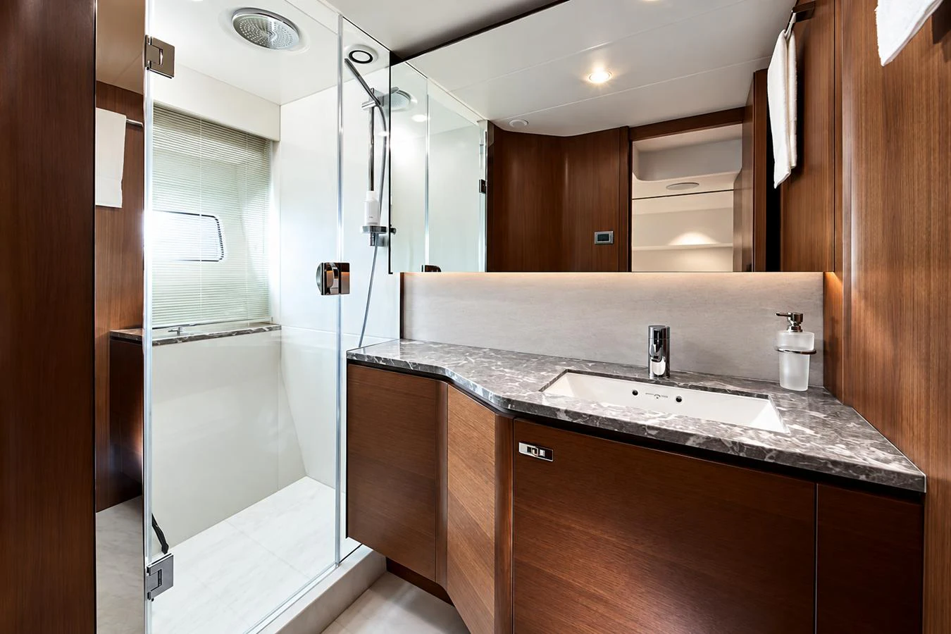The yacht's bathroom features a sleek design with a glass-enclosed shower and modern fixtures. aboard MOONFLOWER Yacht for Sale