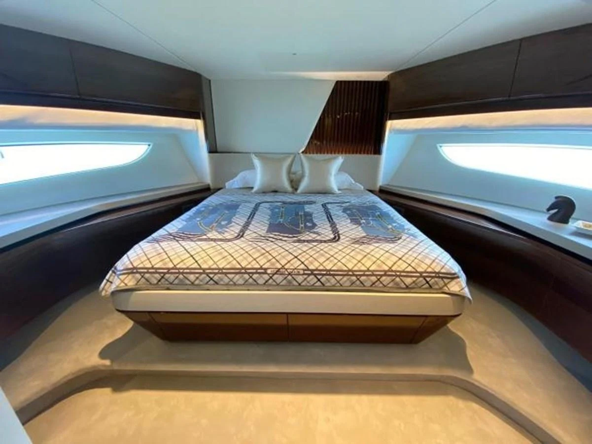 The master stateroom features a luxurious bed with elegant bedding and ample natural light from large windows. aboard MOONFLOWER Yacht for Sale