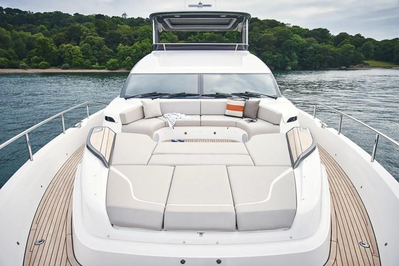 The yacht's foredeck features a spacious and inviting sunpad area with plush seating, perfect for relaxation. aboard MOONFLOWER Yacht for Sale