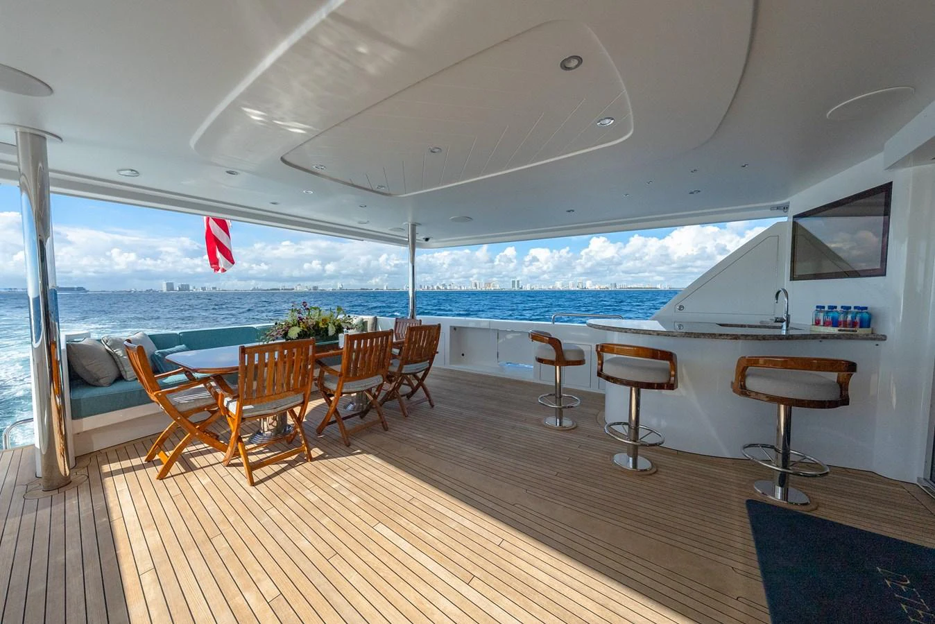 The aft deck offers a spacious and inviting area for dining and relaxation with stunning ocean views. aboard DETERMINATION Yacht for Sale