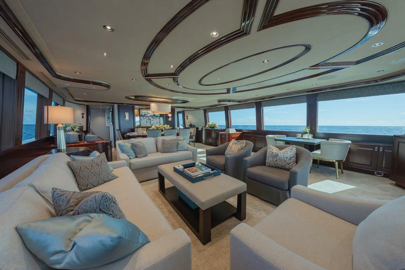 The spacious salon offers luxurious seating with panoramic ocean views. aboard DETERMINATION Yacht for Sale