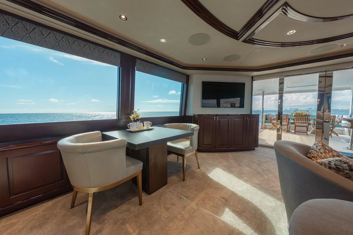 The salon offers a luxurious and comfortable space with panoramic ocean views. aboard DETERMINATION Yacht for Sale