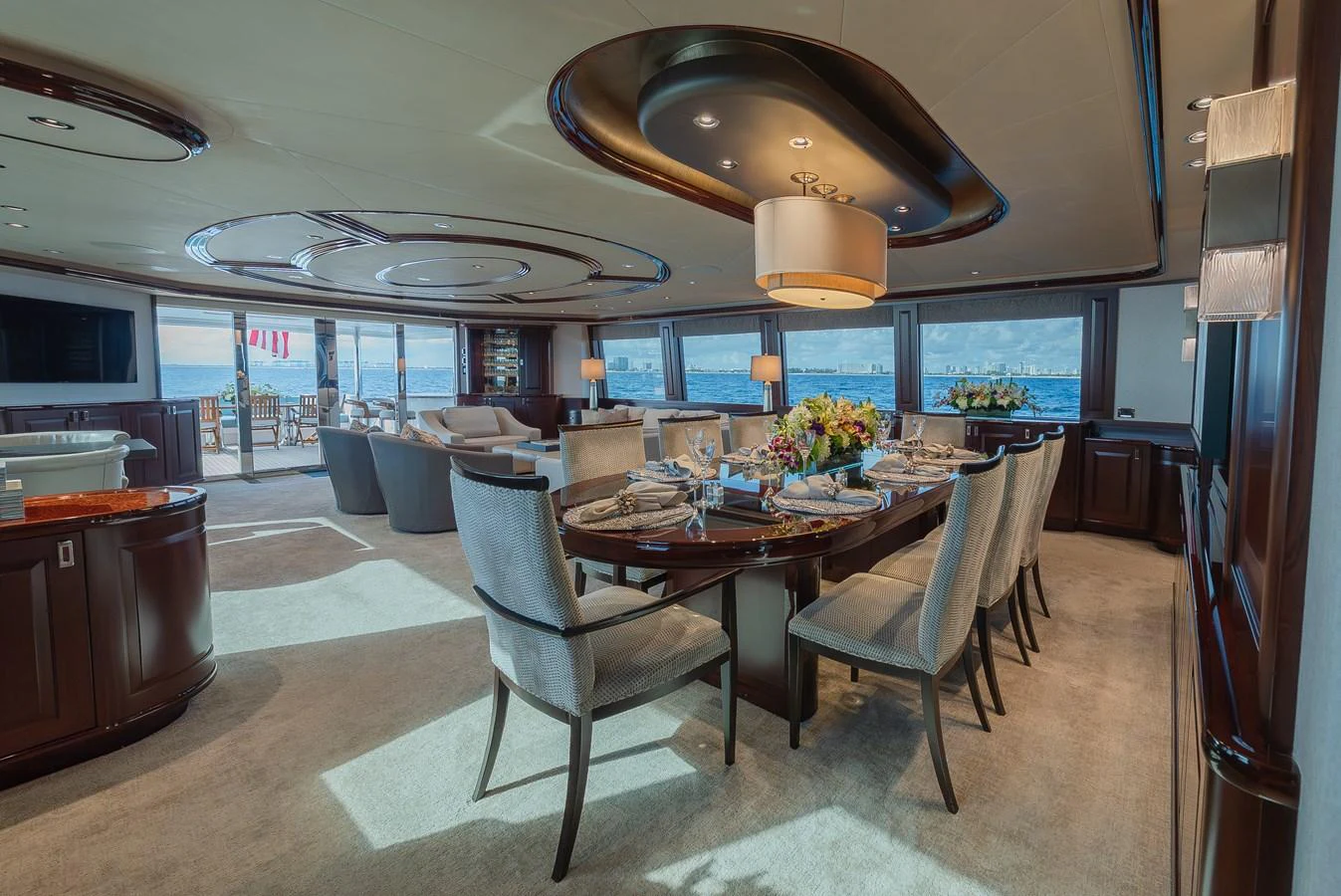 The yacht's dining area features elegant furnishings and panoramic ocean views. aboard DETERMINATION Yacht for Sale