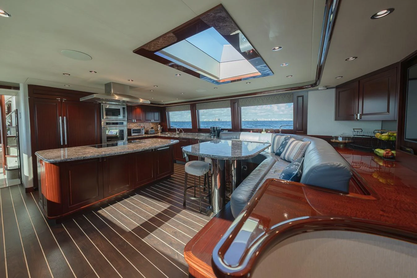 The yacht's galley features a spacious layout with modern appliances and a large seating area. aboard DETERMINATION Yacht for Sale