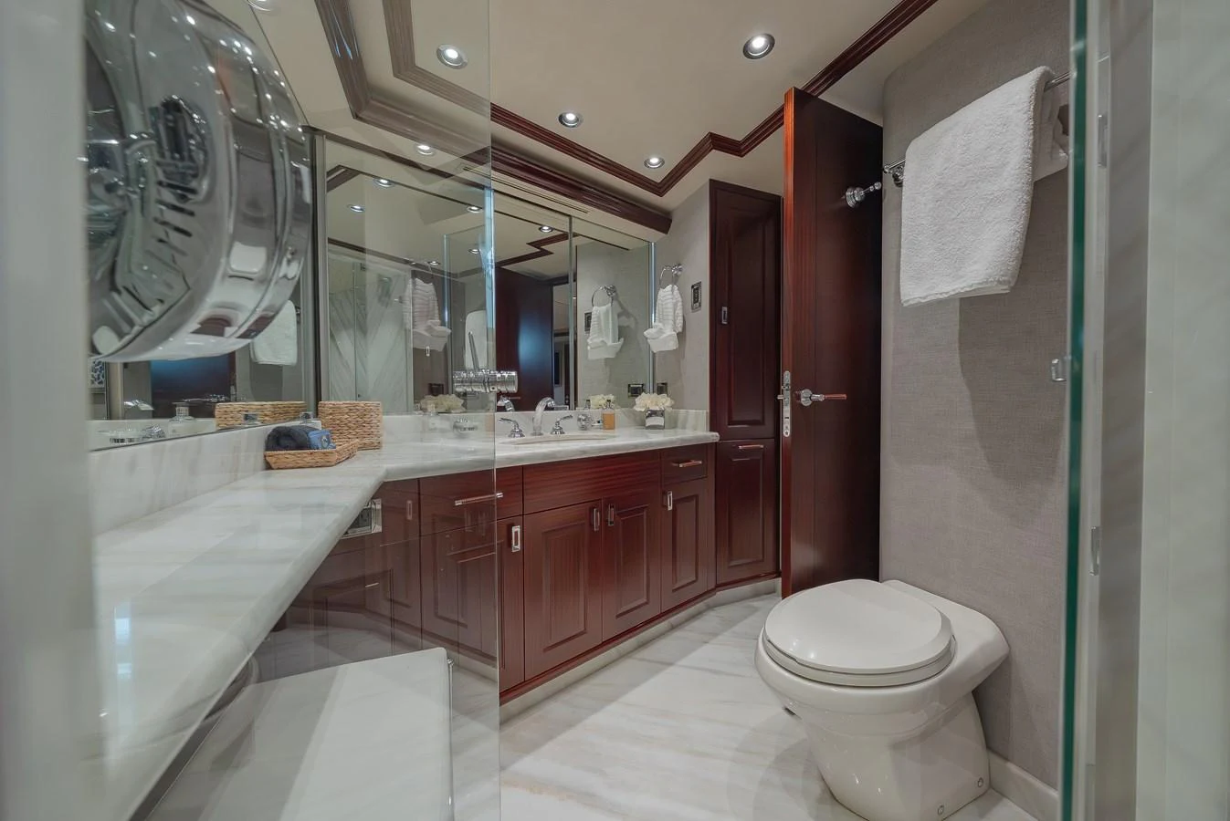 The yacht's bathroom features elegant wood cabinetry and a spacious, well-lit design. aboard DETERMINATION Yacht for Sale