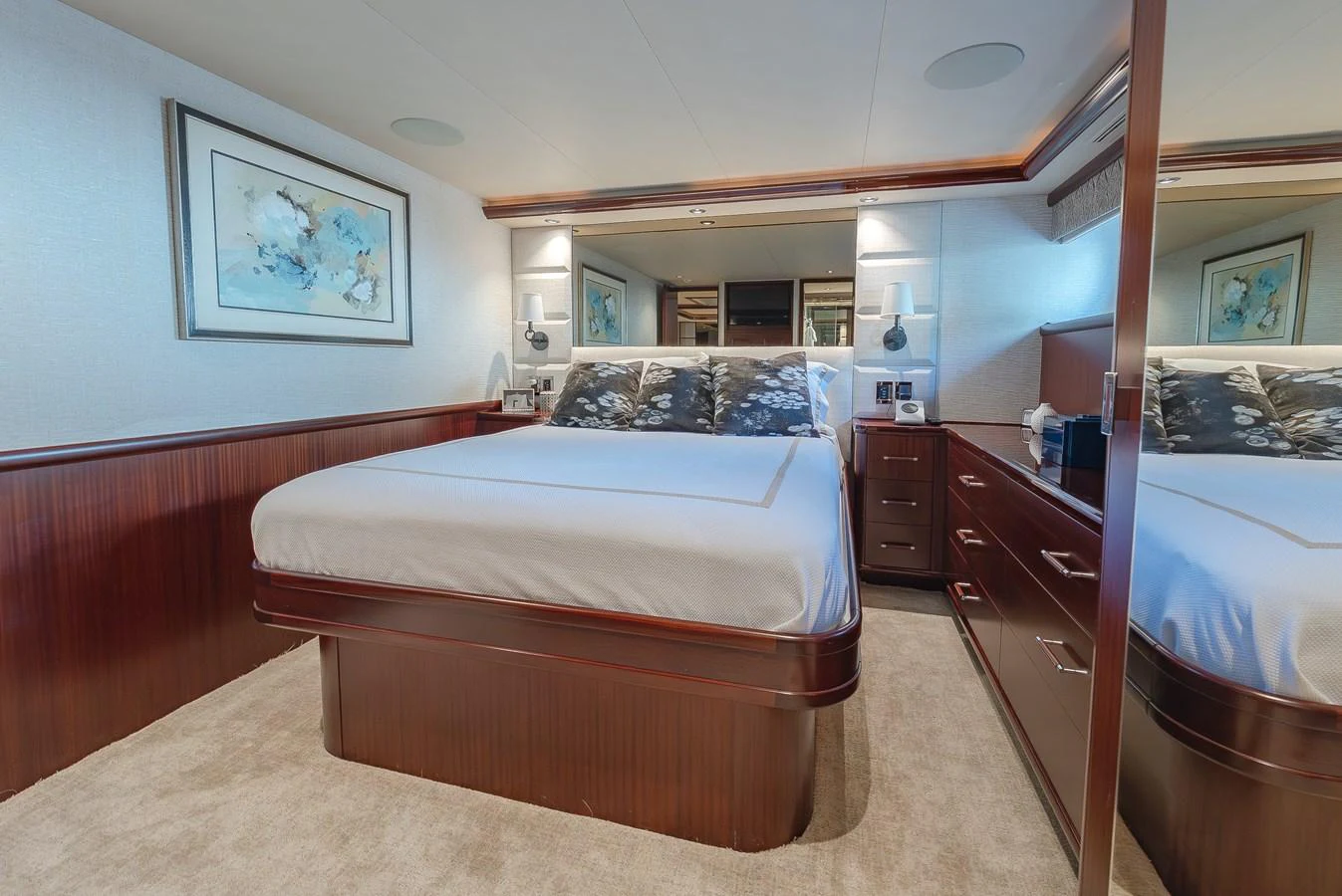 The stateroom features a luxurious bed with elegant wood finishes and modern decor. aboard DETERMINATION Yacht for Sale