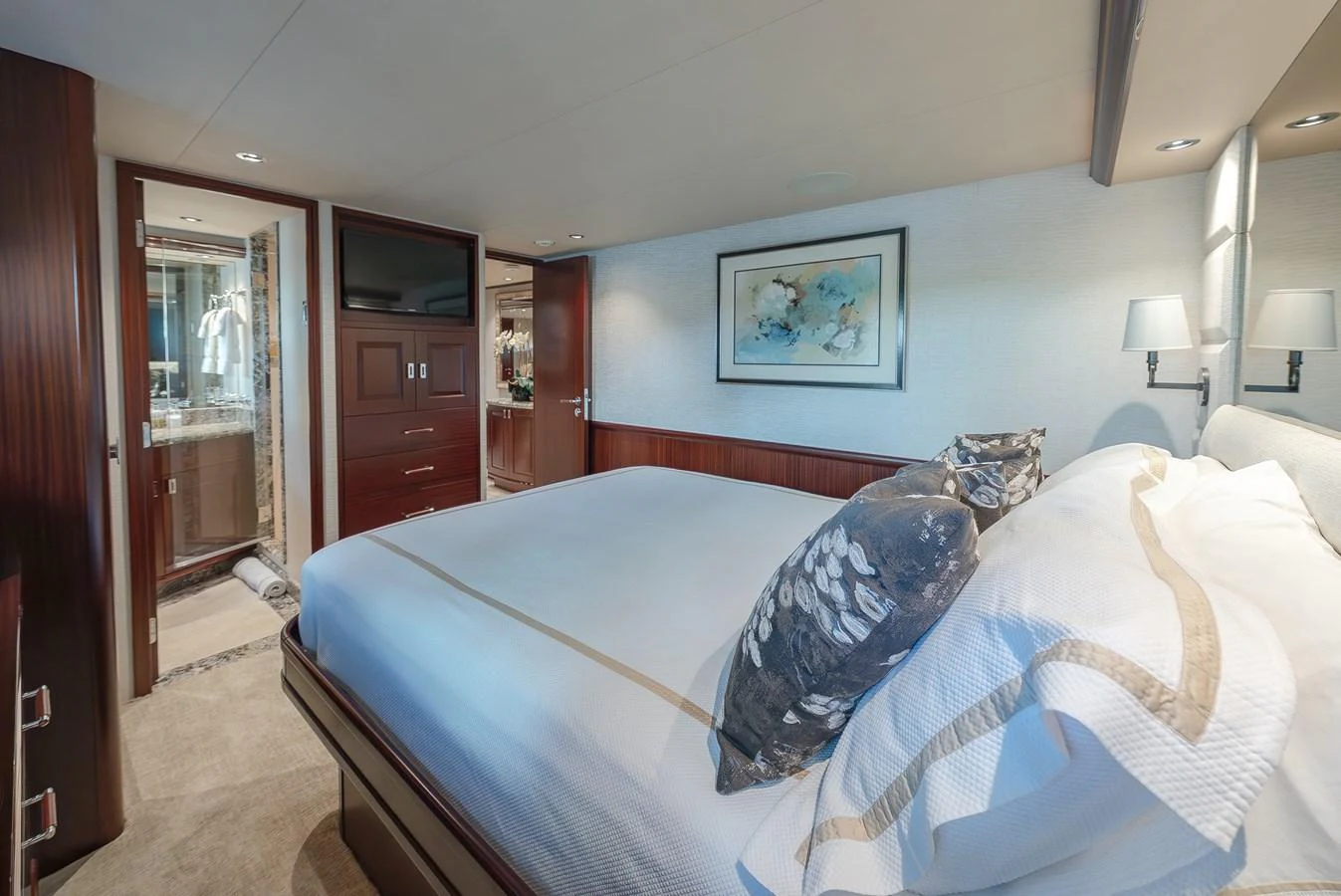 A luxurious stateroom featuring a comfortable bed, elegant decor, and modern amenities. aboard DETERMINATION Yacht for Sale