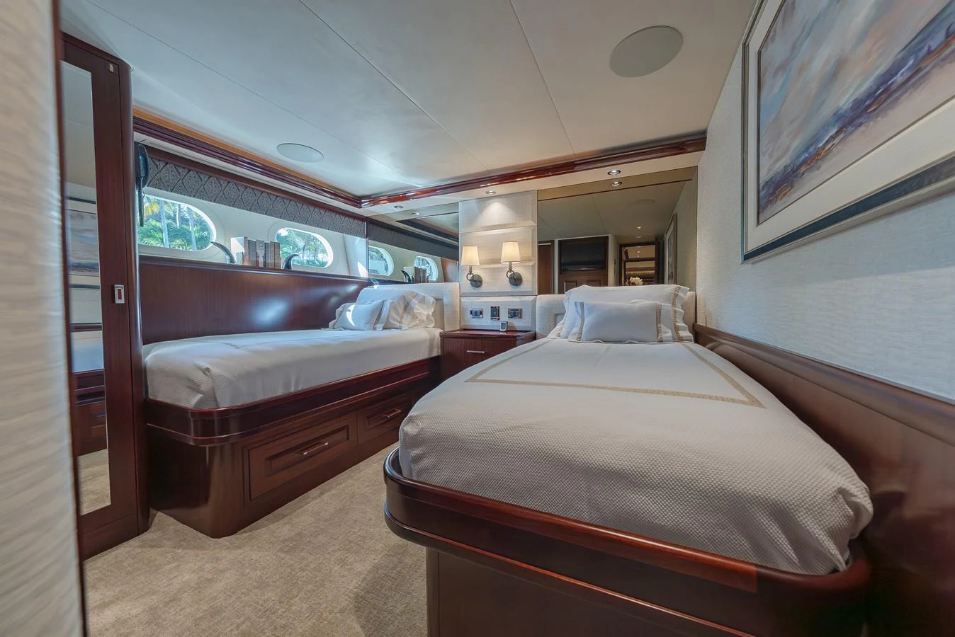 The guest stateroom features twin beds with elegant wood finishes and ample natural light. aboard DETERMINATION Yacht for Sale