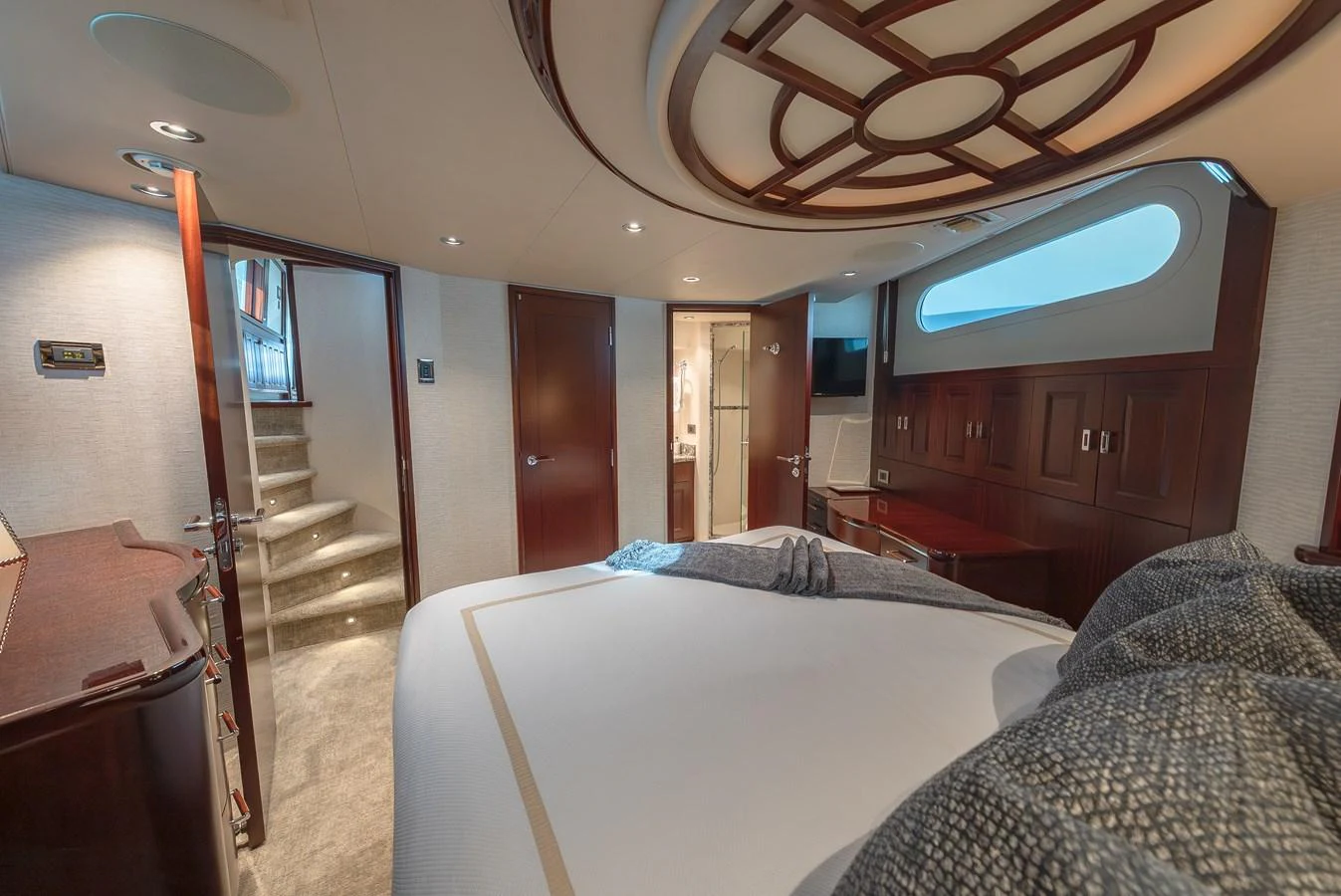 The master stateroom features luxurious bedding and elegant woodwork, creating a serene and inviting atmosphere. aboard DETERMINATION Yacht for Sale