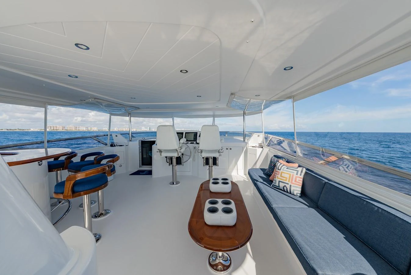 The flybridge offers a spacious and comfortable area with seating and helm stations, perfect for enjoying the open sea. aboard DETERMINATION Yacht for Sale