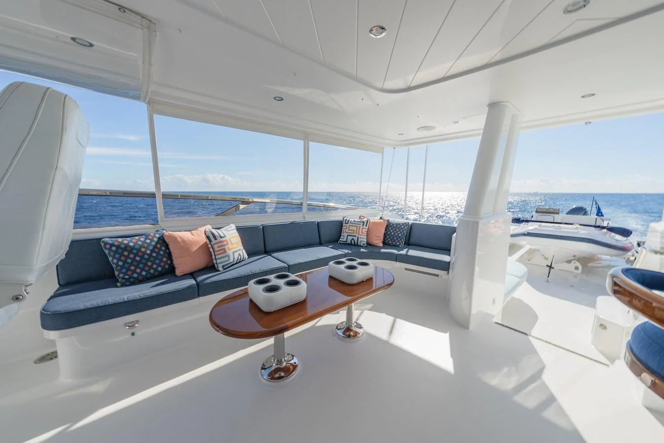 The aft deck features a spacious seating area with plush cushions and a stunning ocean view. aboard DETERMINATION Yacht for Sale