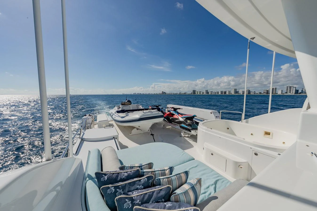 The sundeck offers a luxurious space with comfortable seating and water toys, perfect for enjoying the open sea. aboard DETERMINATION Yacht for Sale