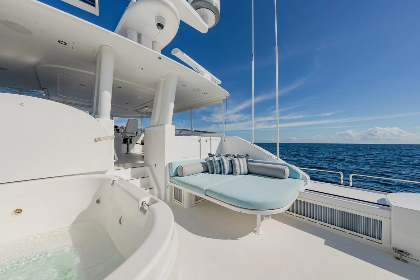 The sundeck features a luxurious jacuzzi and a comfortable lounging area with stunning ocean views. aboard DETERMINATION Yacht for Sale