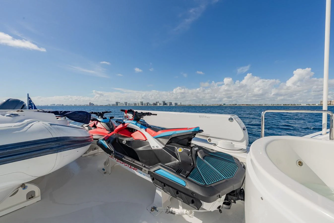 The yacht's deck features jet skis ready for thrilling water adventures. aboard DETERMINATION Yacht for Sale