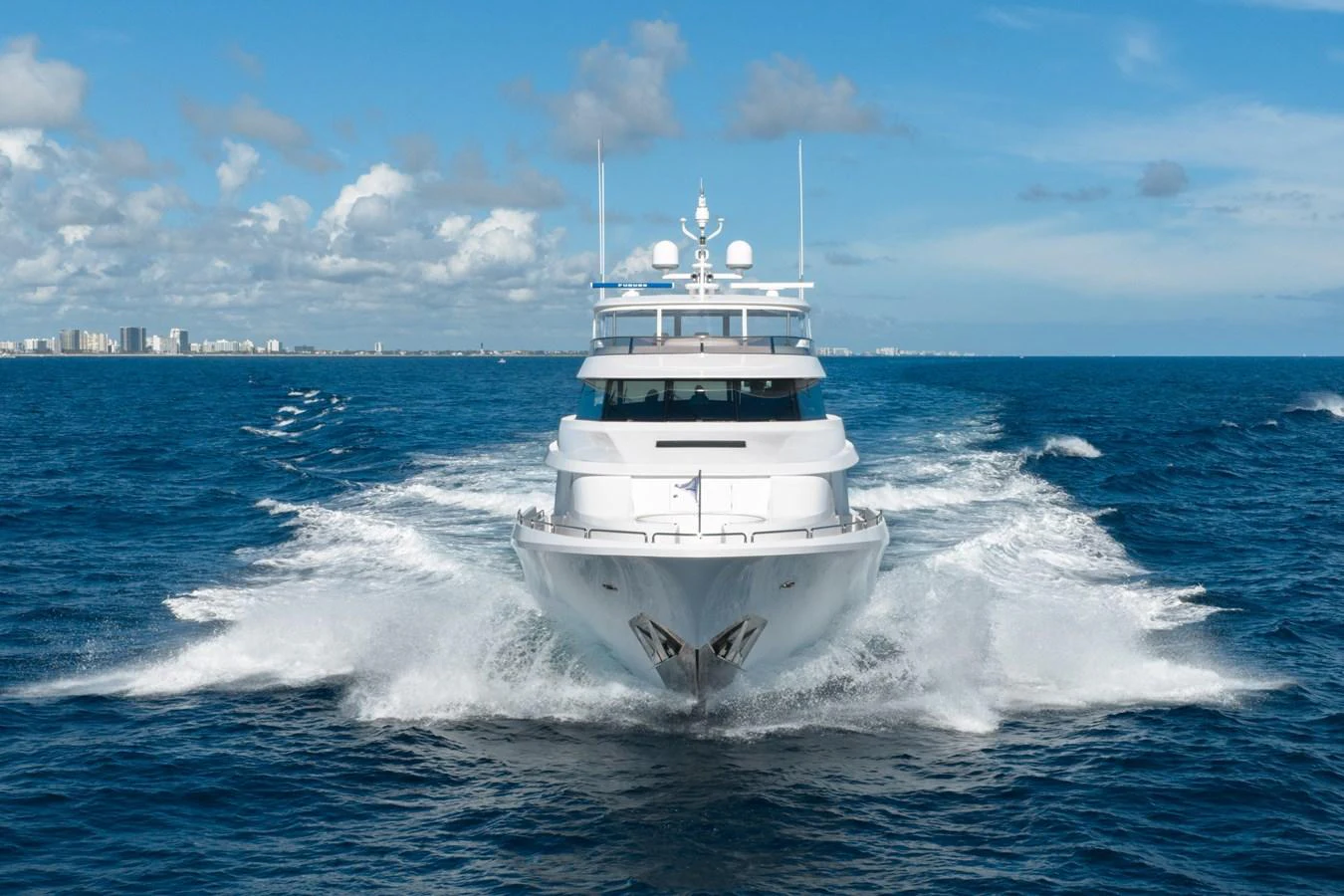 A stunning yacht cuts through the open ocean, showcasing its sleek design and powerful presence. aboard DETERMINATION Yacht for Sale
