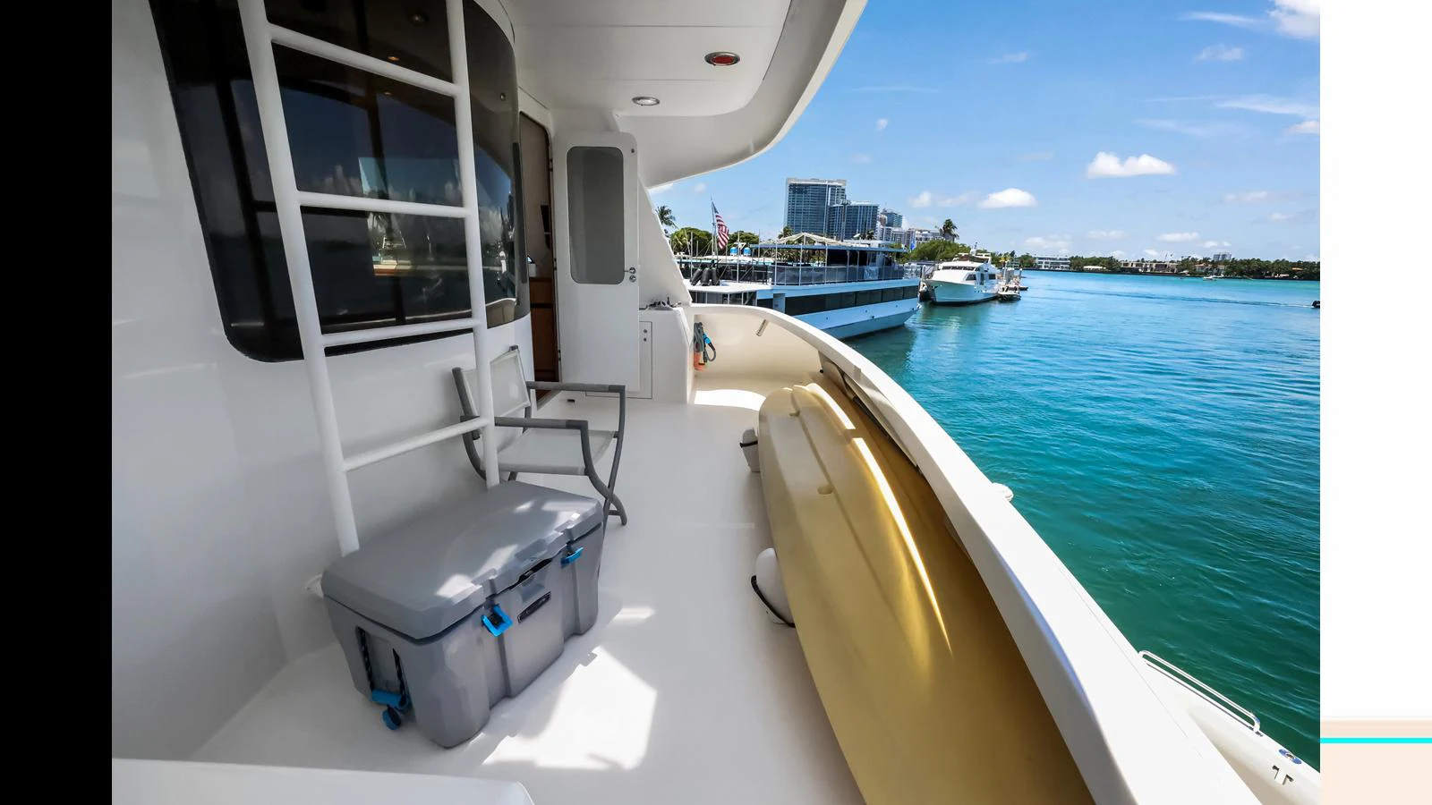 The side deck offers a serene view of the water, perfect for relaxation. aboard MOANA Yacht for Sale