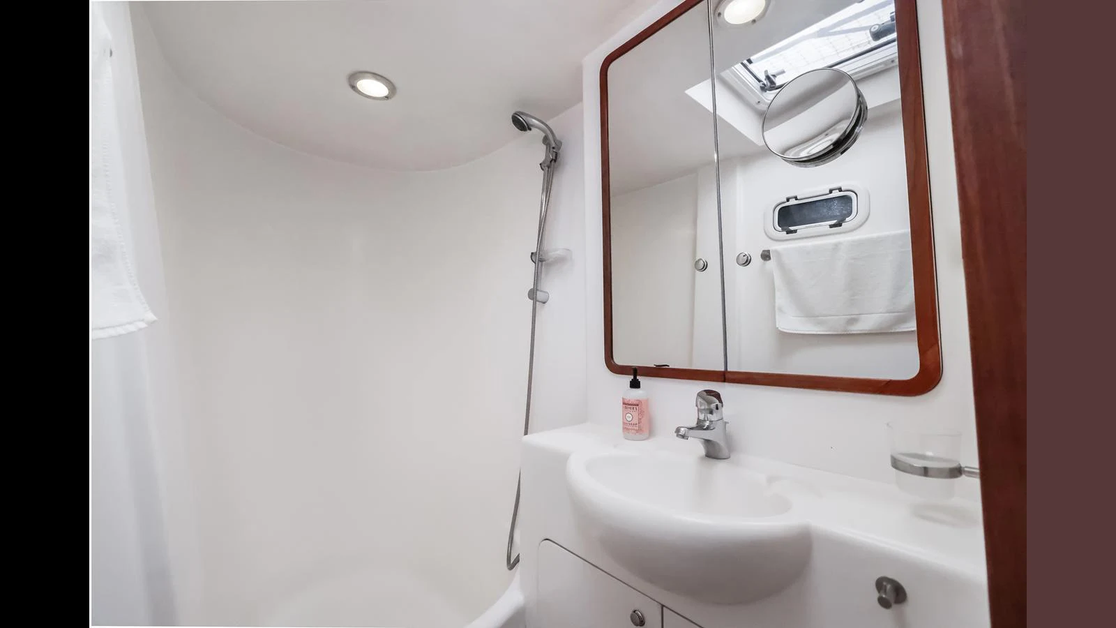 The yacht's bathroom features a sleek and modern design with a compact yet functional layout. aboard MOANA Yacht for Sale