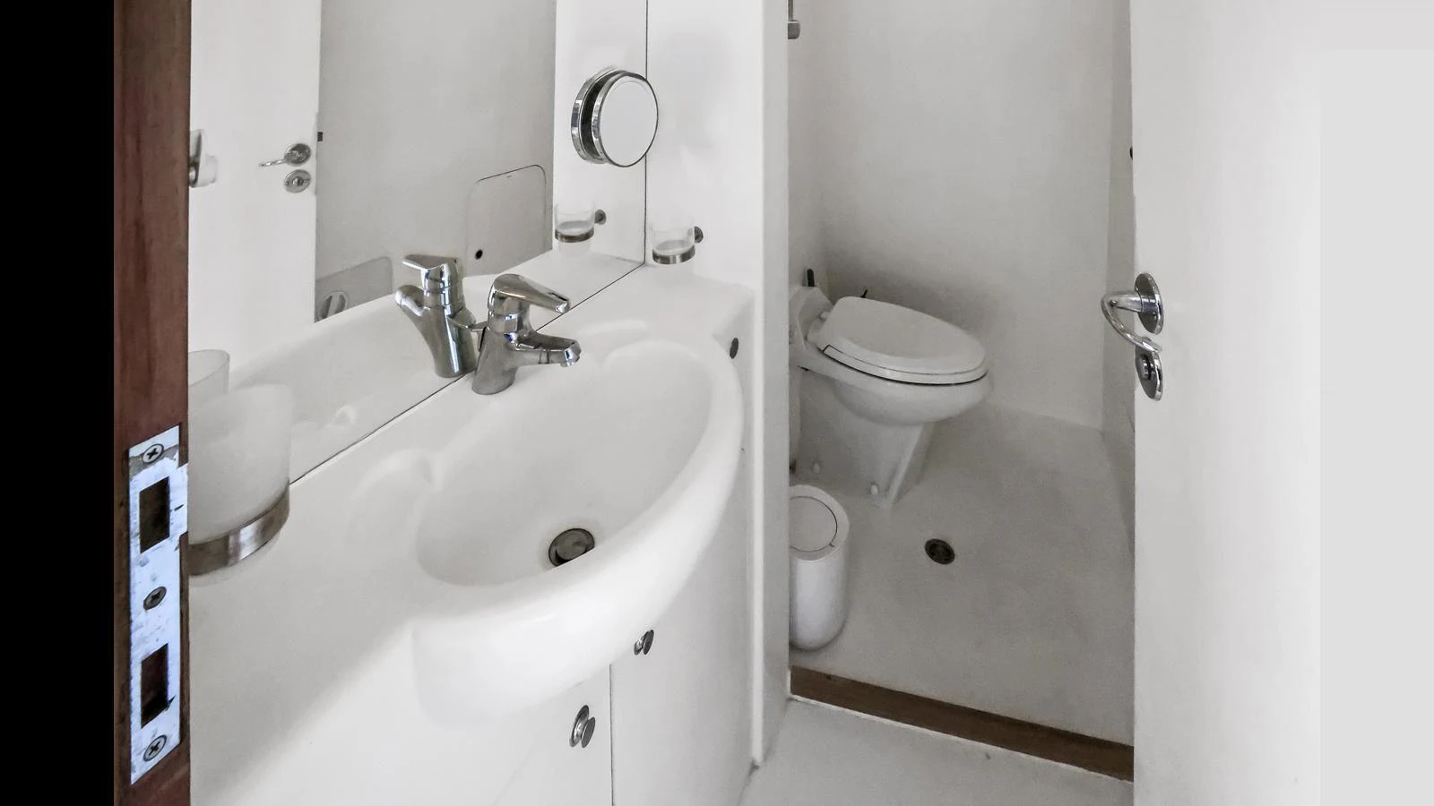 The yacht's bathroom features a clean and modern design with a white sink and toilet. aboard MOANA Yacht for Sale