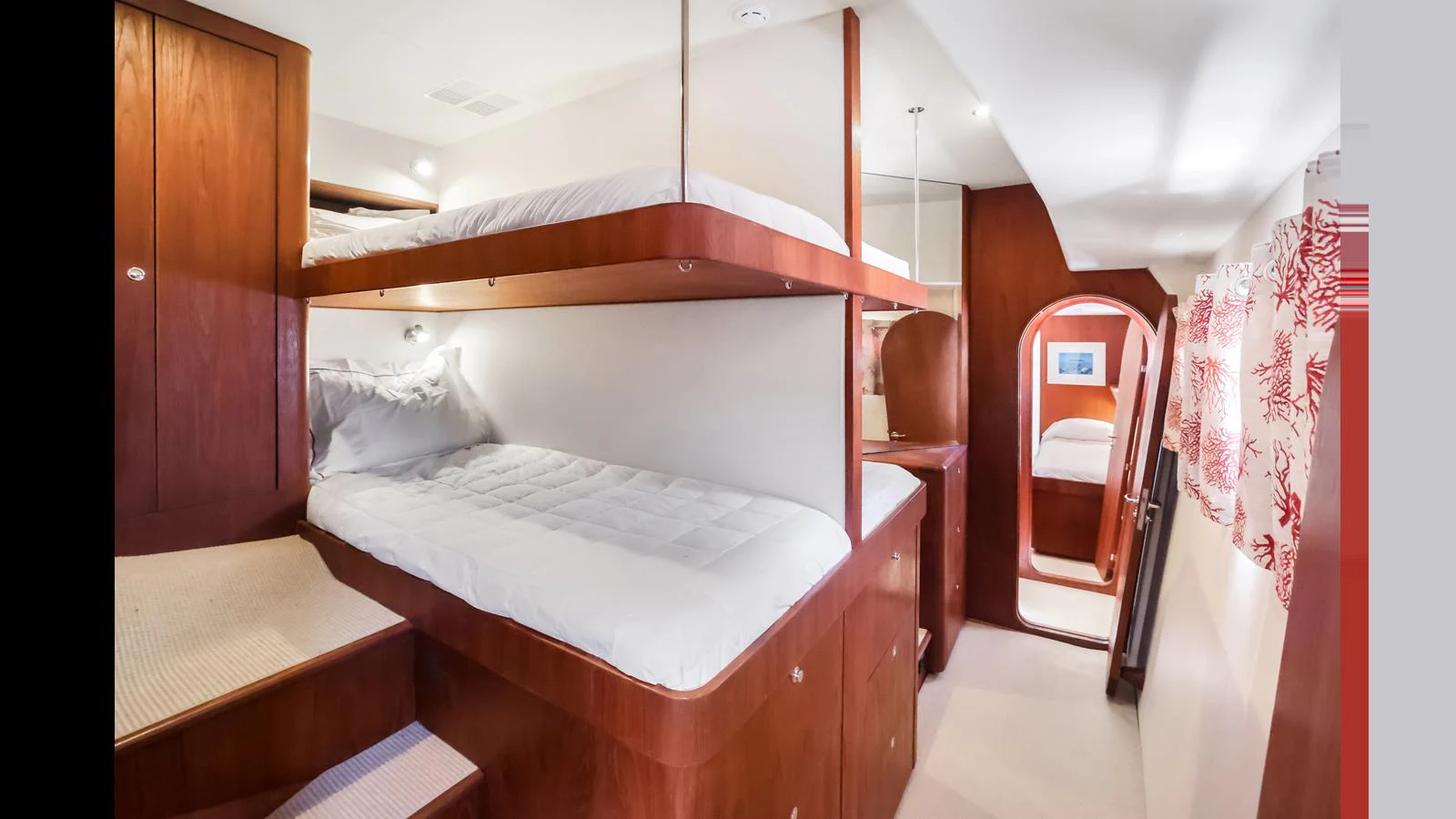 The cozy cabin features wooden bunk beds and a warm, inviting atmosphere. aboard MOANA Yacht for Sale