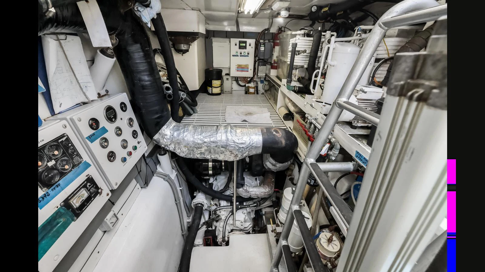 The image showcases the yacht's well-maintained engine room with various mechanical components and control panels. aboard MOANA Yacht for Sale