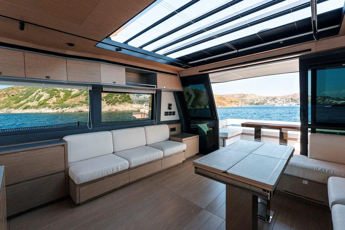 The salon offers a spacious and modern seating area with panoramic views and ample natural light. aboard LUCKY LUKA Yacht for Sale