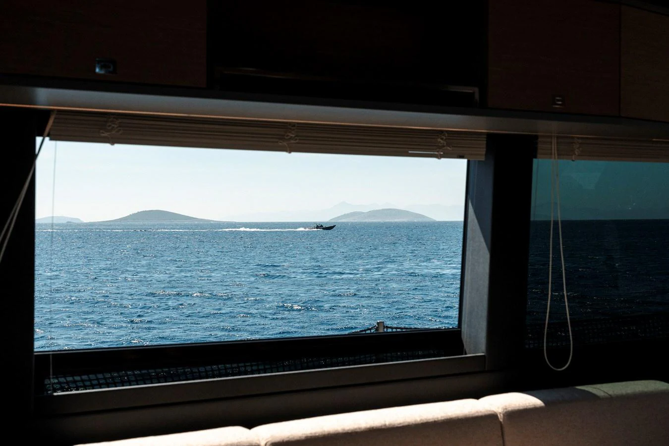 A serene view of the ocean through a large window from the yacht's interior. aboard LUCKY LUKA Yacht for Sale