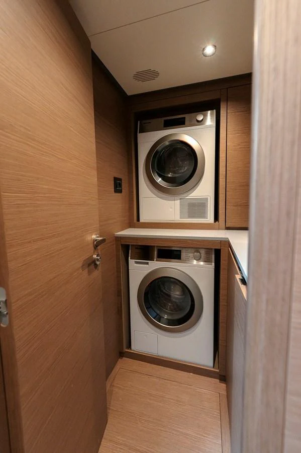 The yacht features a compact and efficient laundry room with modern appliances. aboard LUCKY LUKA Yacht for Sale