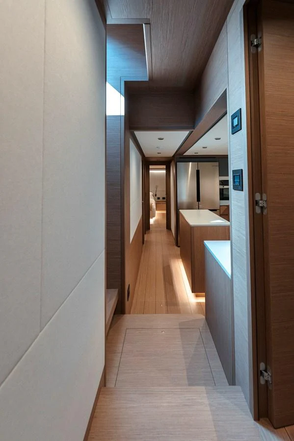 A sleek and modern hallway with wooden finishes leads to various rooms on the yacht. aboard LUCKY LUKA Yacht for Sale