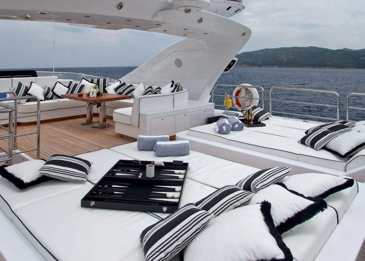 The sundeck offers luxurious lounging with plush seating and scenic ocean views. aboard RUSH Yacht for Sale