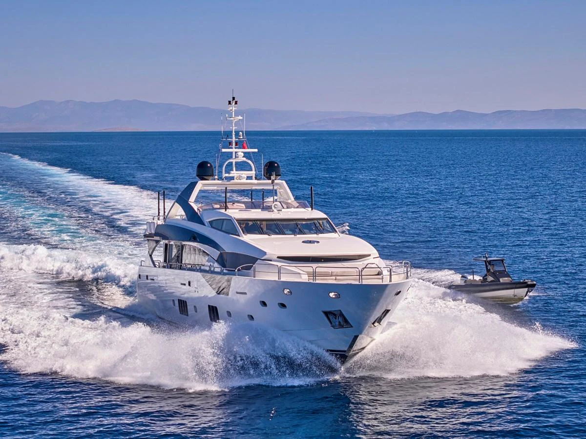 A luxurious yacht cruises swiftly through the open sea, leaving a trail of white foam in its wake. aboard BLADE I Yacht for Sale