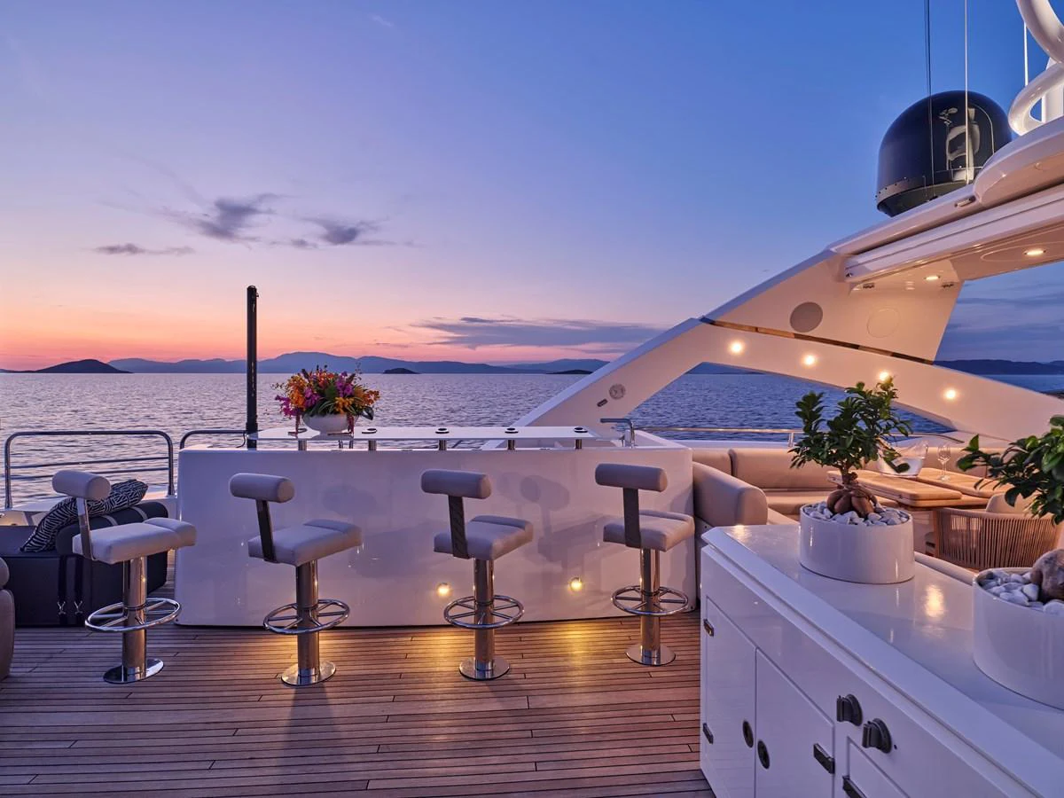 The flybridge offers a luxurious bar area with stunning sunset views over the water. aboard BLADE I Yacht for Sale