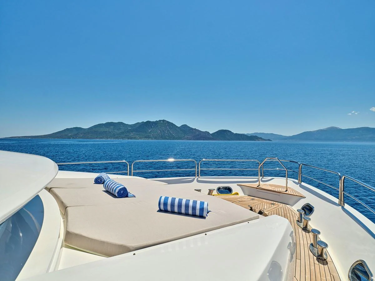 The sundeck offers a serene space for relaxation with plush sun pads and a stunning ocean view. aboard BLADE I Yacht for Sale