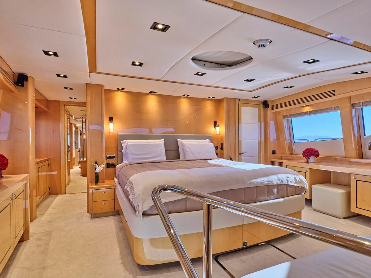 The master stateroom features a spacious bed, elegant lighting, and large windows for natural light. aboard BLADE I Yacht for Sale