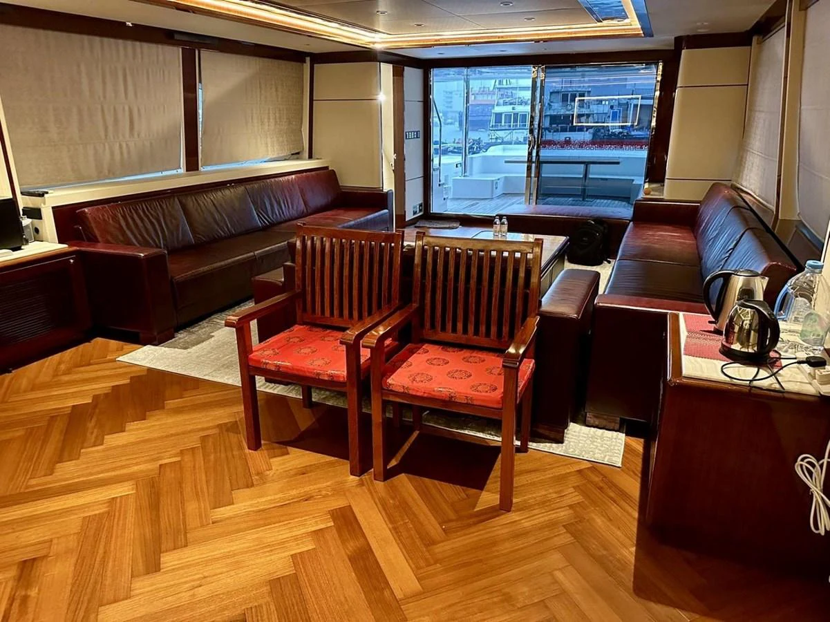 The yacht's interior features a spacious and elegant seating area with wooden flooring and comfortable furnishings. aboard HEYSEA ASTERIA 126/1 Yacht for Sale