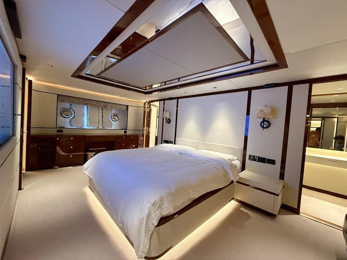 The master stateroom features a luxurious bed with elegant lighting and ample storage space. aboard HEYSEA ASTERIA 126/1 Yacht for Sale