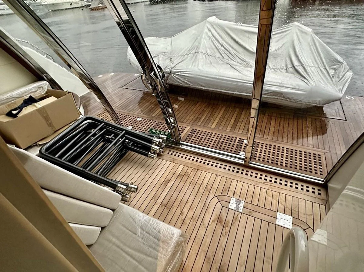 The aft deck features a spacious area with wooden flooring and covered outdoor furniture, perfect for relaxation. aboard HEYSEA ASTERIA 126/1 Yacht for Sale